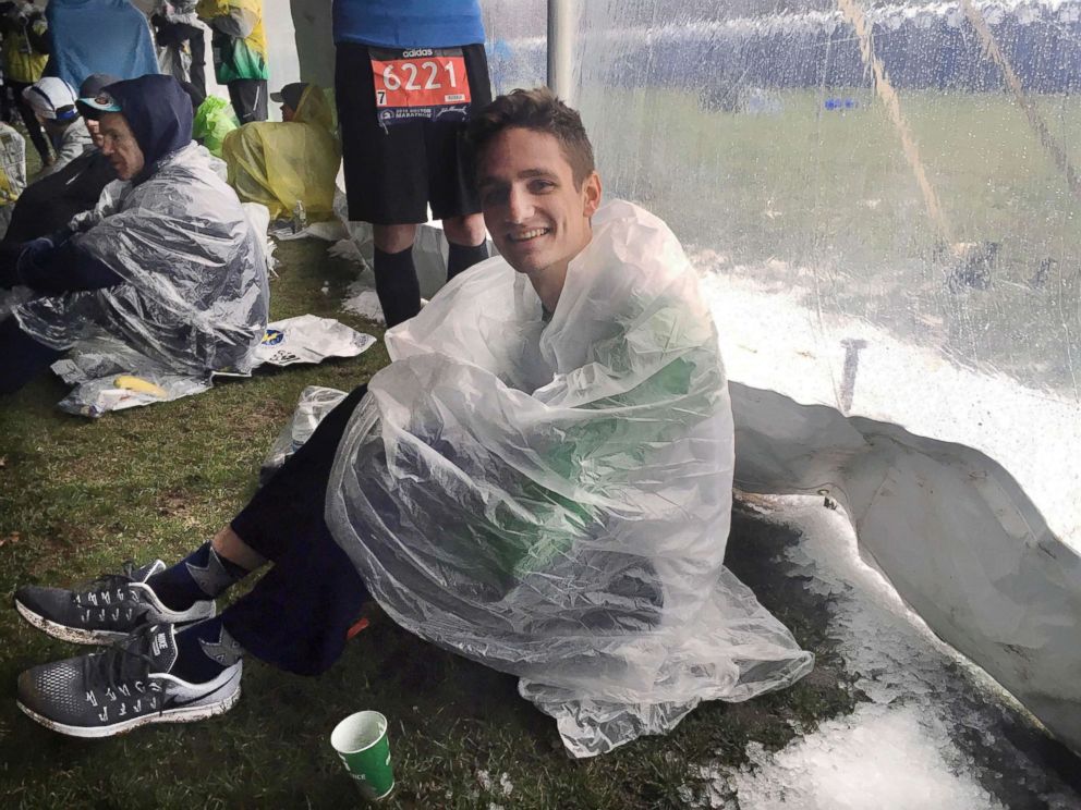 PHOTO: Connor Buchholz, 25, of Toledo, Ohio, waits under a tent beside ice crystals that accumulated at the athletes village before the start of the the 122nd Boston Marathon, April 16, 2018, in Hopkinton, Mass.