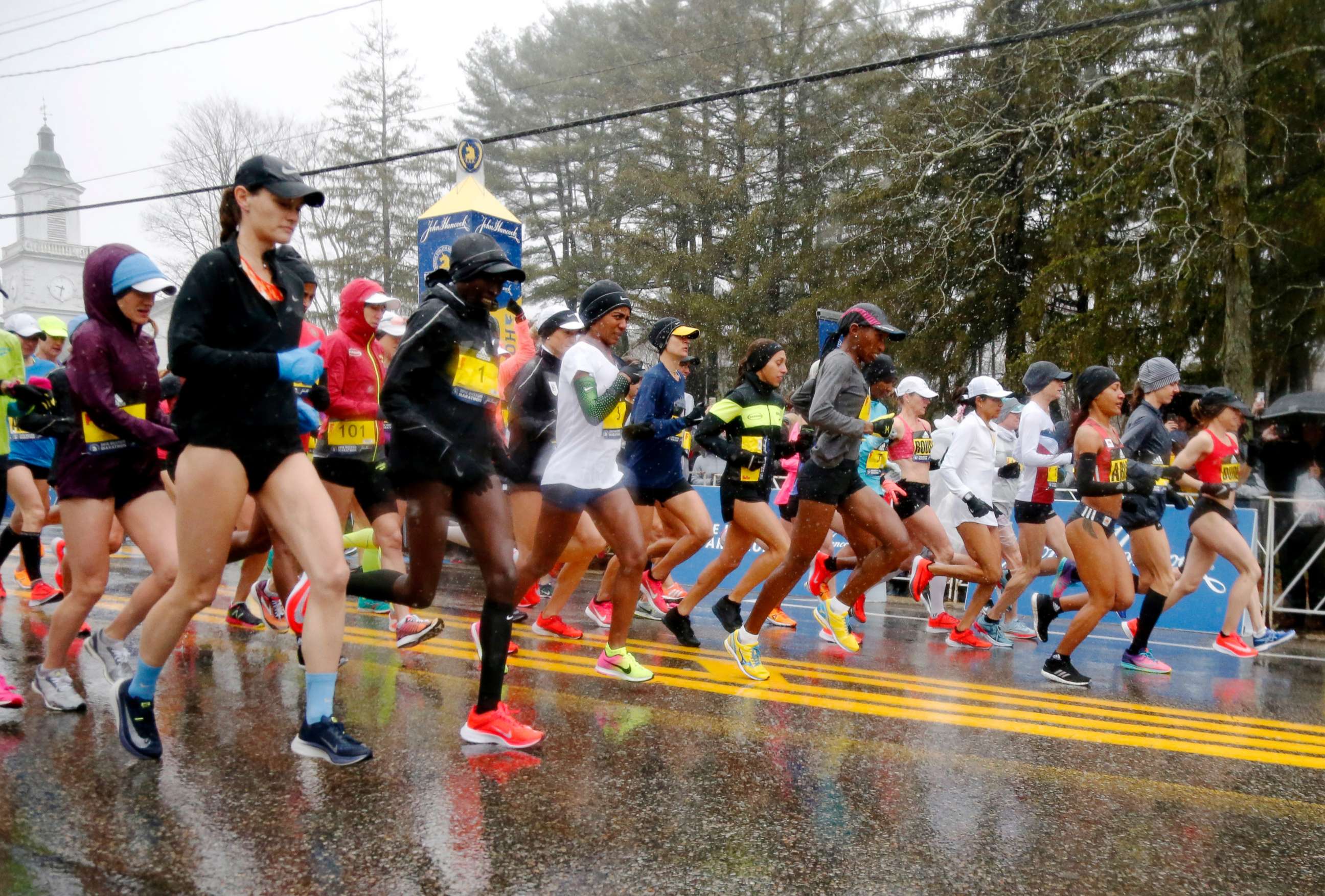 PHOTO: The elite female runners break from the starting line in a downpour during the 122nd running of the Boston Marathon in Hopkinton, Mass., April 16, 2018.