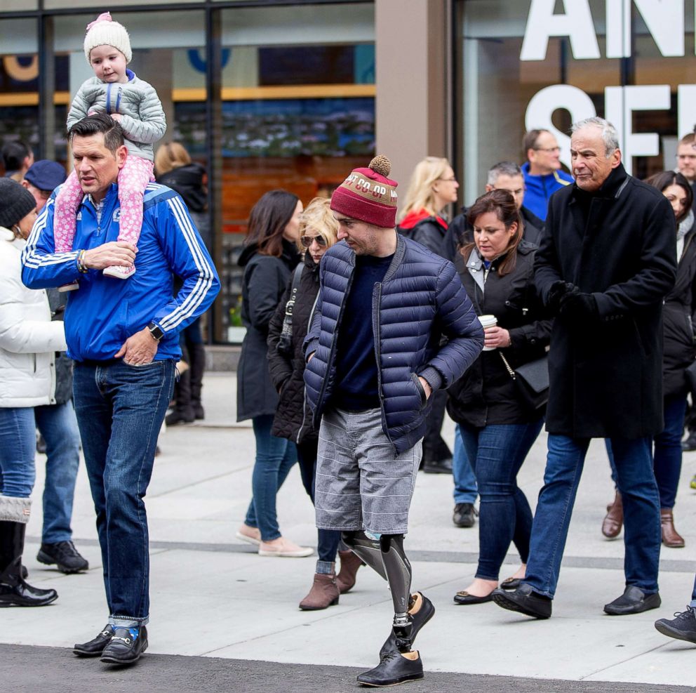 PHOTO: Boston Marathon Bombing victim Jeff Bauman, center, who lost both of his legs from the explosion walks the location of the first explosion, during a memorial ceremony on the fifth anniversary of the Boston Marathon Bombing, Boston April 15, 2018.