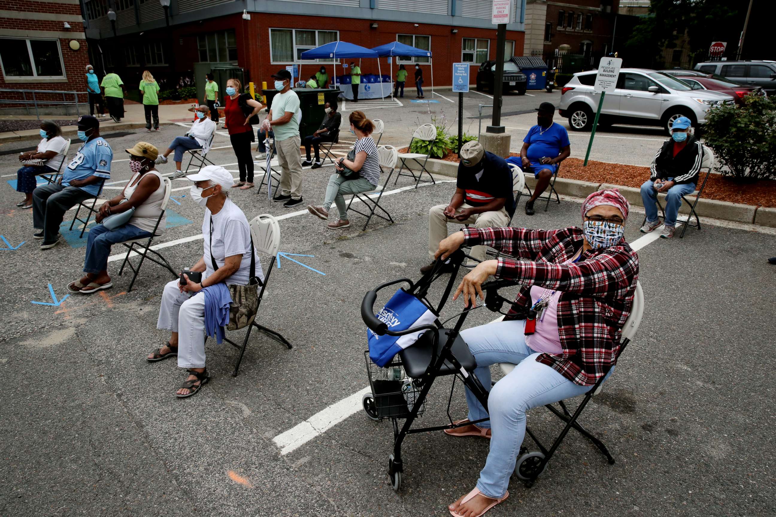 PHOTO: A woman waits to be tested for Covid-19 outside the Catherine Hardaway Residences in the Roxbury neighborhood of Boston, July 08, 2020.