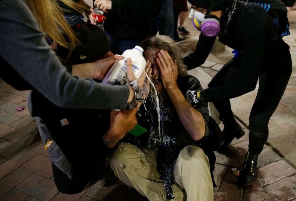 PHOTO: A man who was pepper sprayed by police has milk poured on his face in Downtown Crossing after a march held to protest the death of George Floyd in Boston, May 31, 2020.