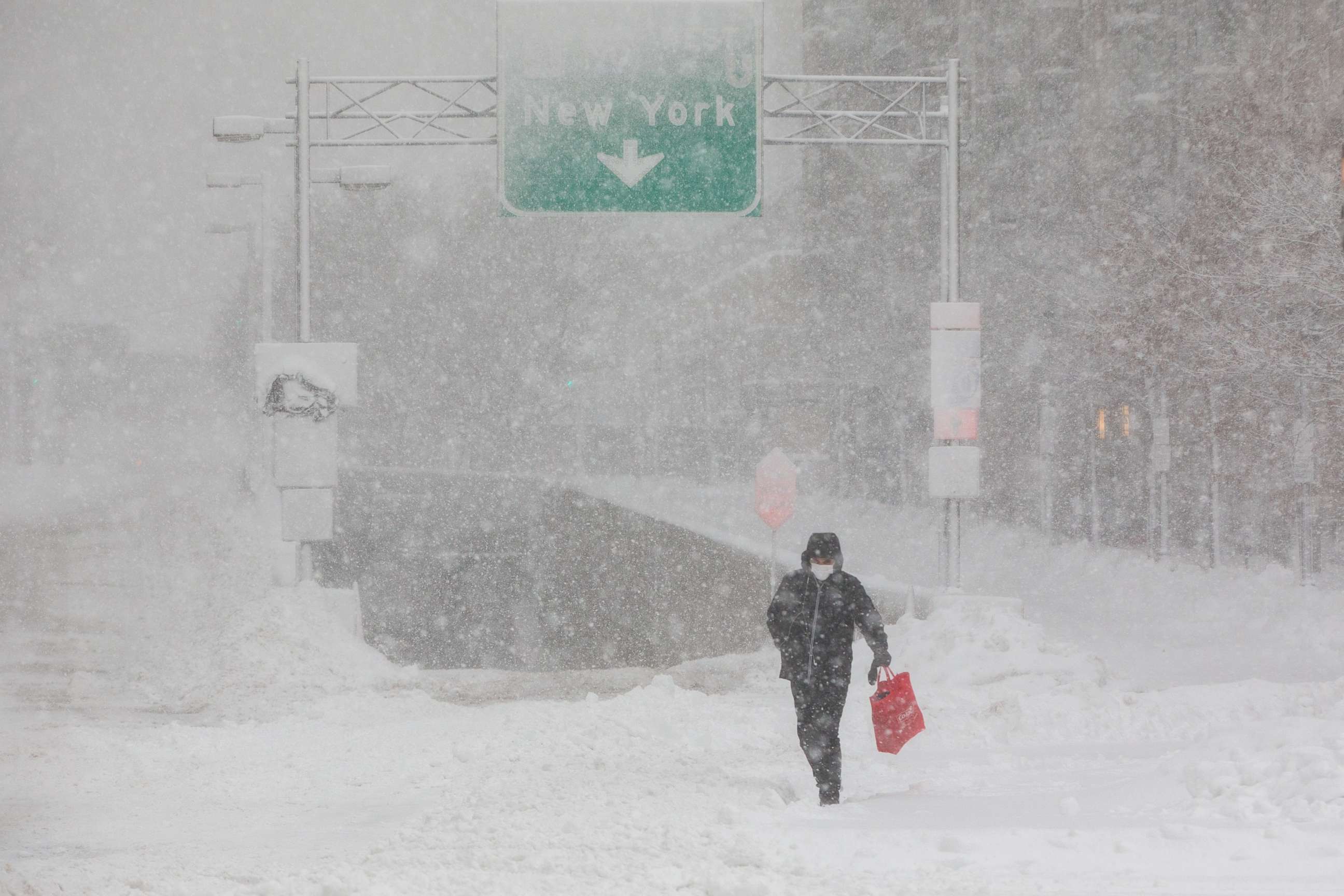 PHOTO: A pedestrian crosses in front of the entrance to I-90 on Dec. 17, 2020 in Boston, Massachusetts.