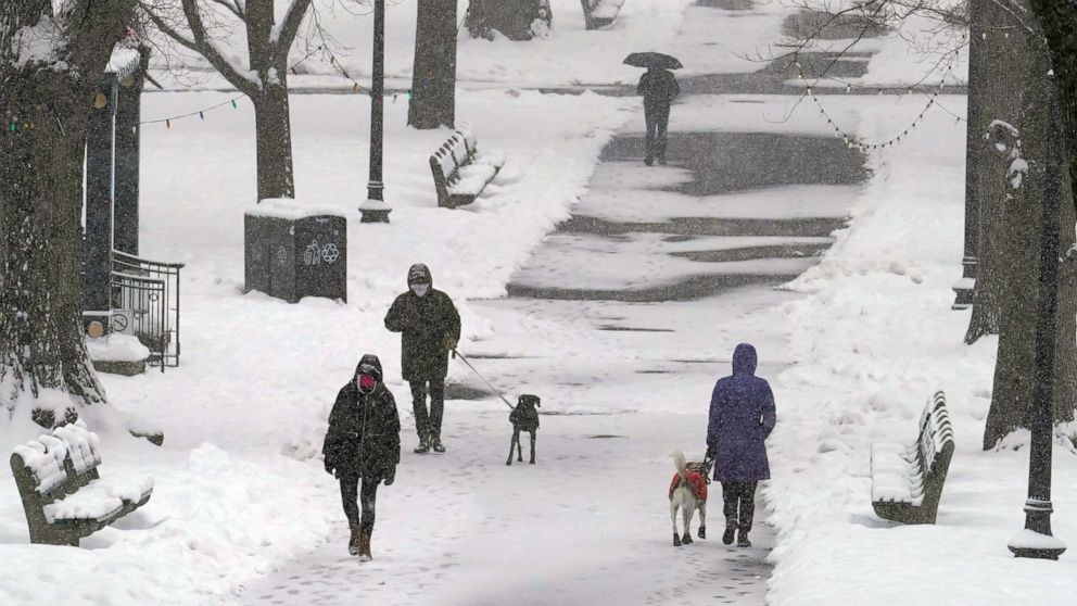 PHOTO: Pedestrians walk along a snow-covered path in the Boston Common, Tuesday, Feb. 9, 2021, in Boston, Mass. 