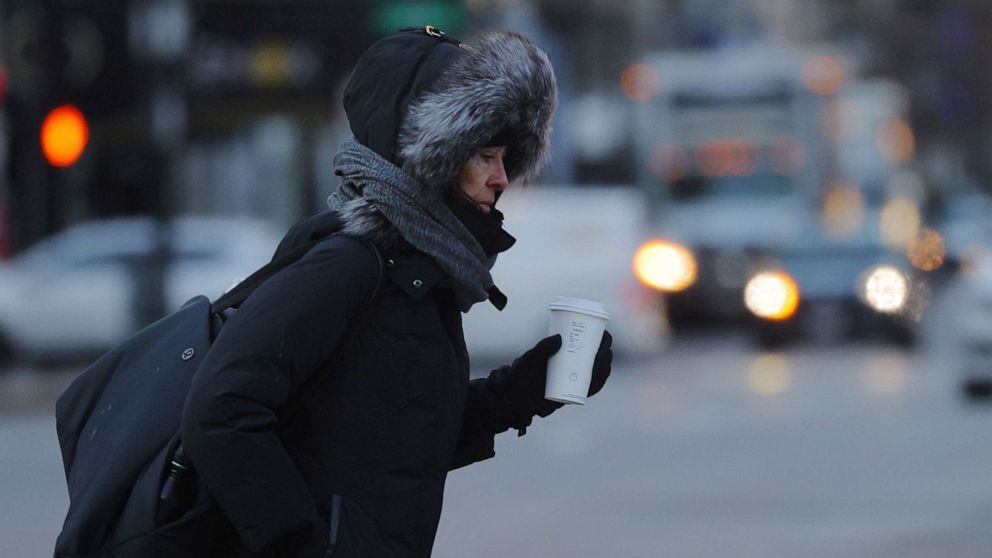 PHOTO: A pedestrian crosses the street on a cold winter morning in Boston, Feb. 3, 2023.