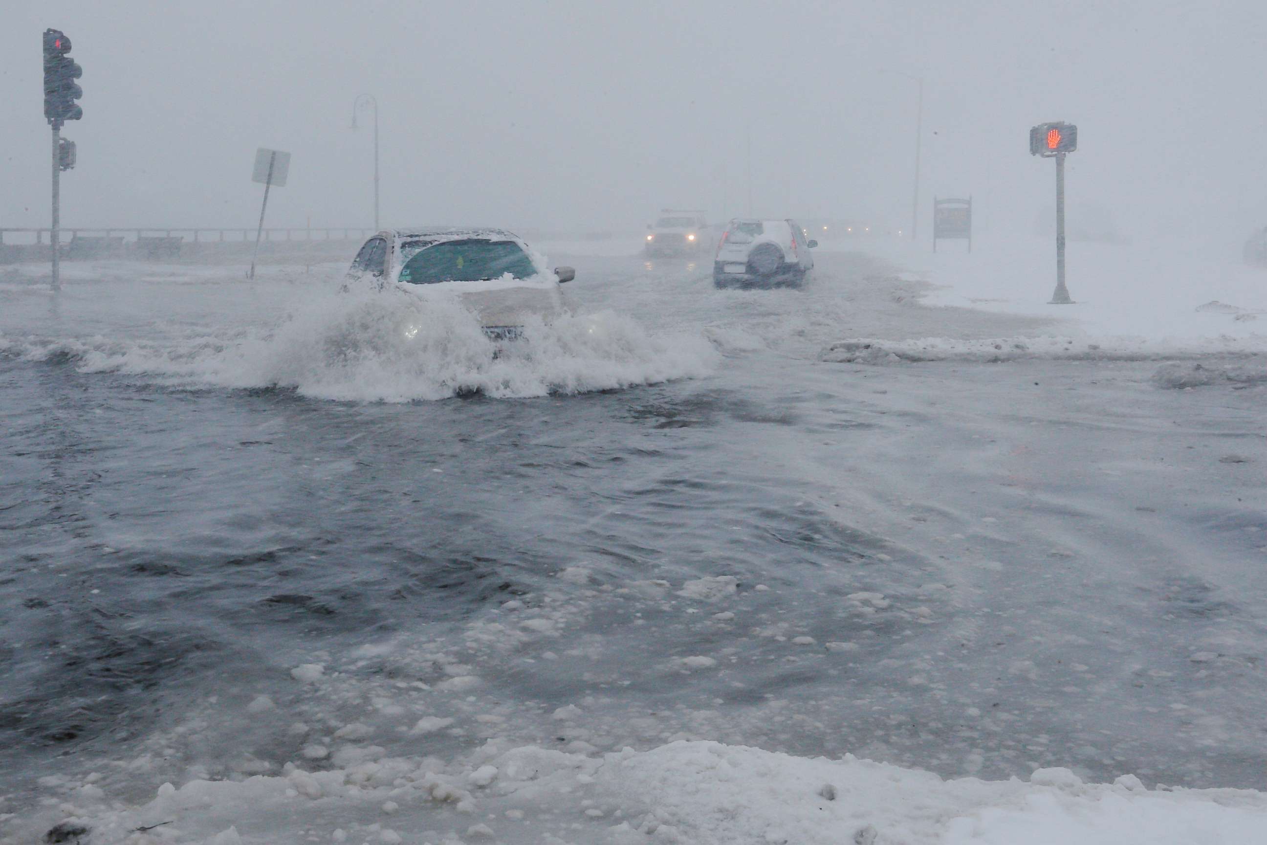 PHOTO: Drivers make their way along the flooded Beach Road after the ocean overtopped the seawall during a winter snowstorm in the Boston suburb of Lynn, Mass., Jan. 4, 2018.