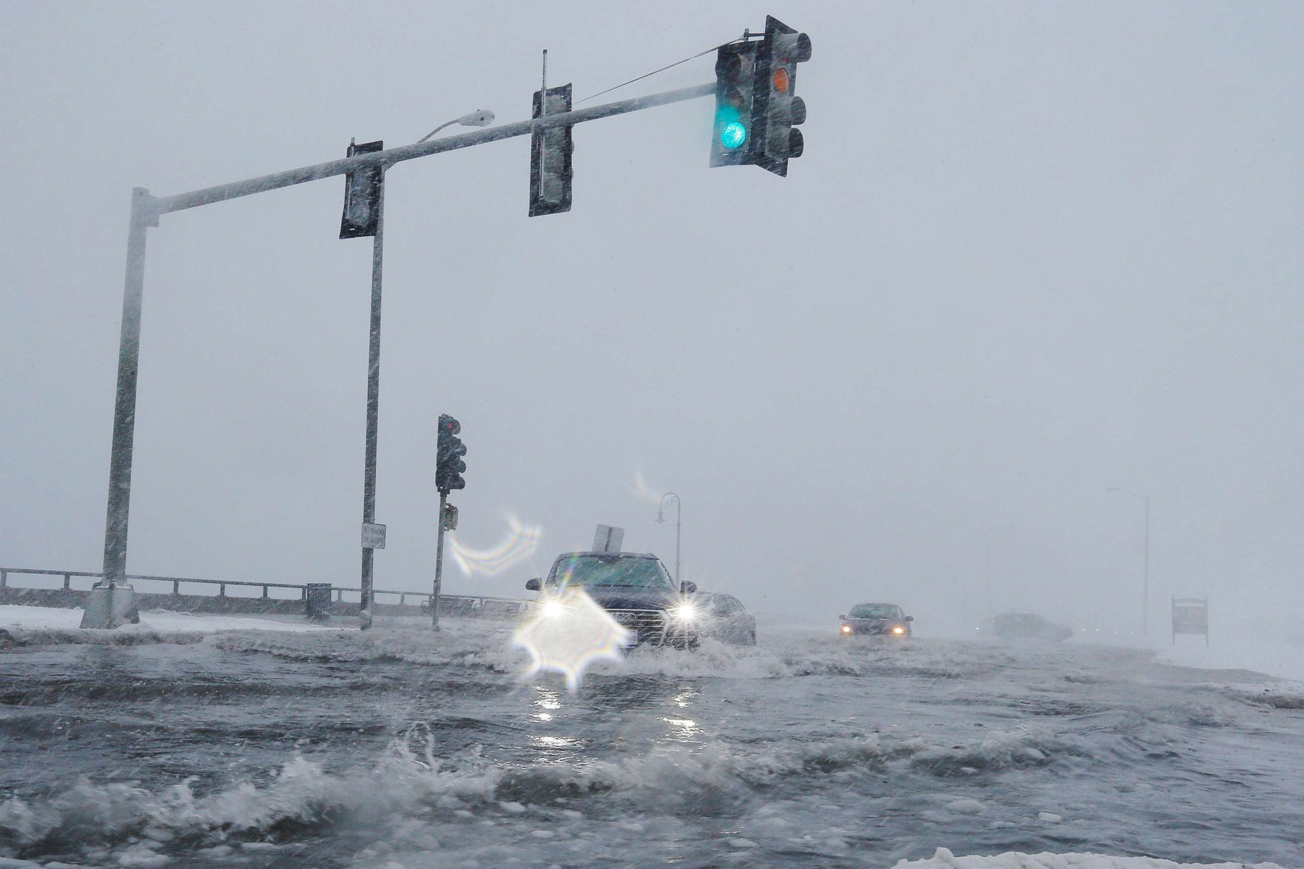 PHOTO: Drivers make their way along the flooded Beach Road after the ocean overtopped the seawall during a winter snowstorm in the Boston suburb of Lynn, Mass., Jan. 4, 2018.