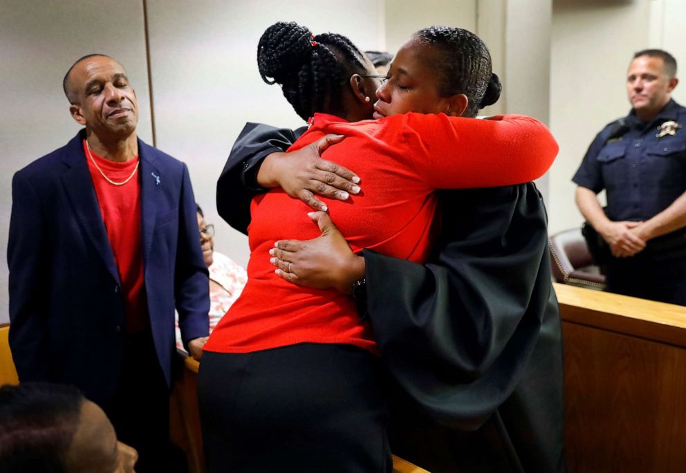 PHOTO: State District Judge Tammy Kemp, right, gives Botham Jean's mother, Allison Jean, a hug while Botham's father, Bertrum Jean, stands at left, following the 10-year sentence given to former Dallas Police Officer Amber Guyger, Oct. 2, 2019, in Dallas.