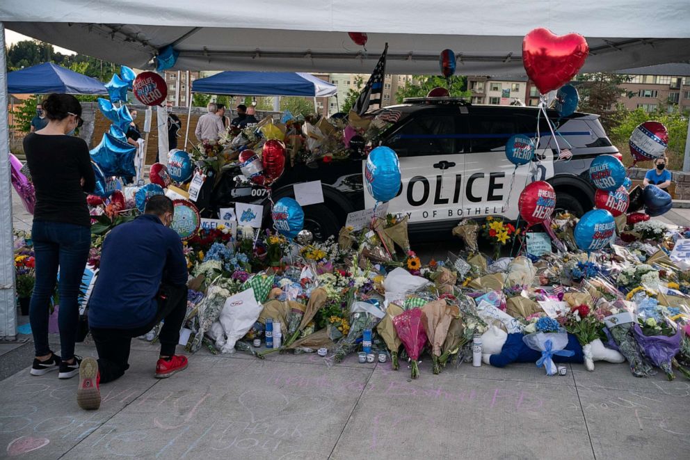 PHOTO: People visit a memorial for slain Police Officer Jonathan Shoop outside the Bothell Police Department on July 14, 2020 in Bothell, Wash. Shoop was shot and killed after a pursuit following a traffic stop Monday.
