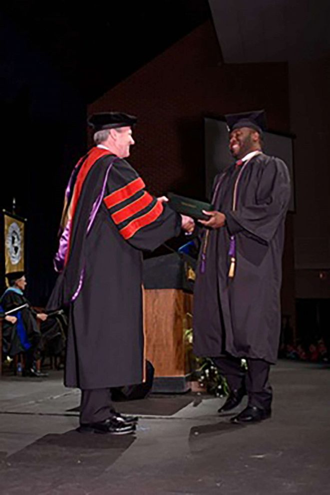 PHOTO: Botham Jean, right, seen during a graduation ceremony at Harding University.