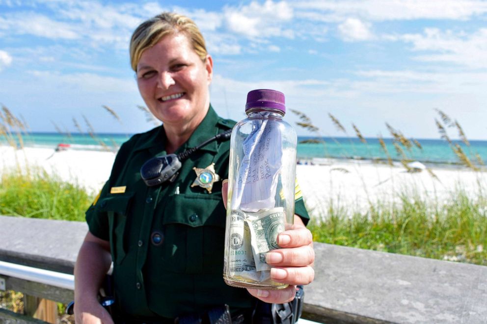 PHOTO: In this undated photo provided by the Walton County Sheriff's Office Sgt. Paula Pendleton  poses with a bottle that washed ashore near Miramar Beach, Fla.