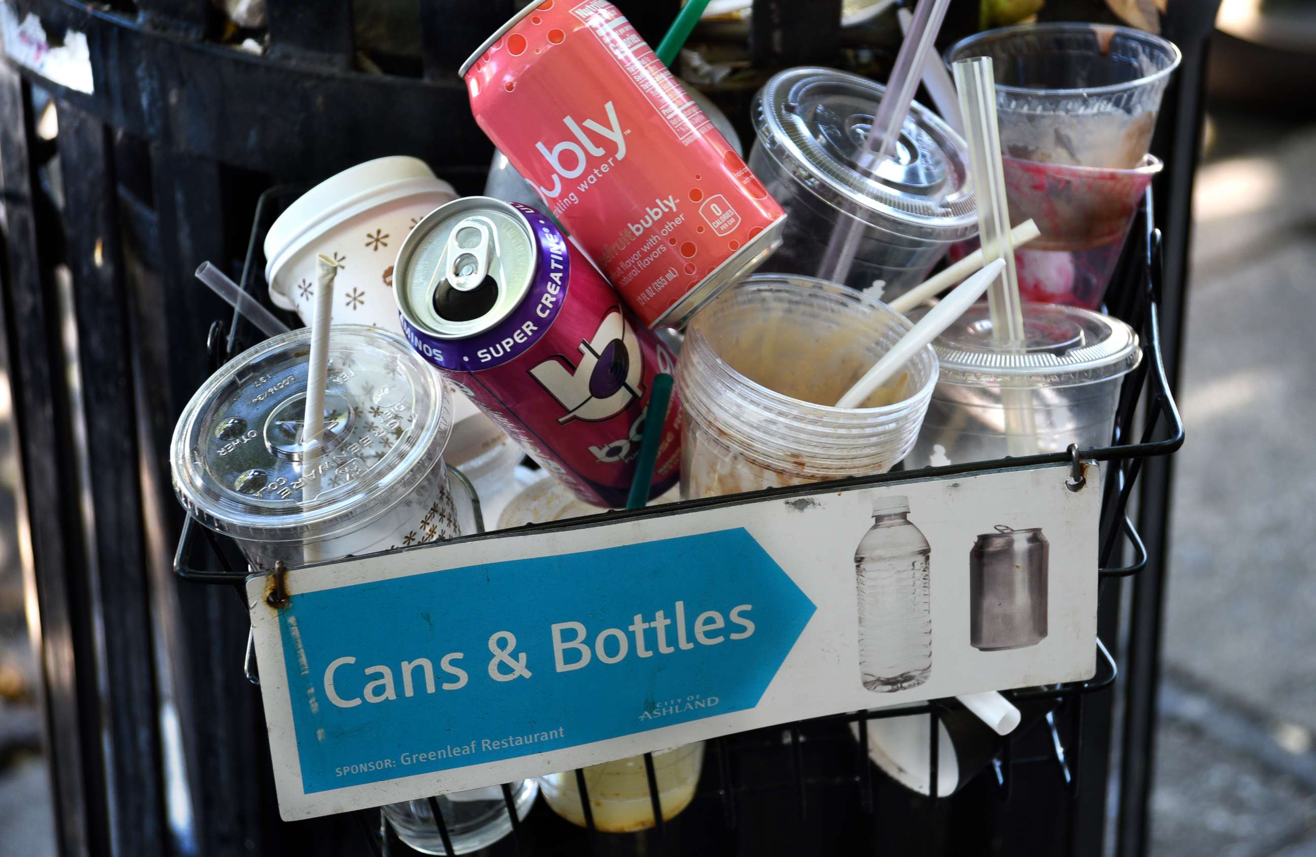 PHOTO: Cups, straws and cans sit in a recycling receptacle in Ashland, Ore., June 17, 2019.