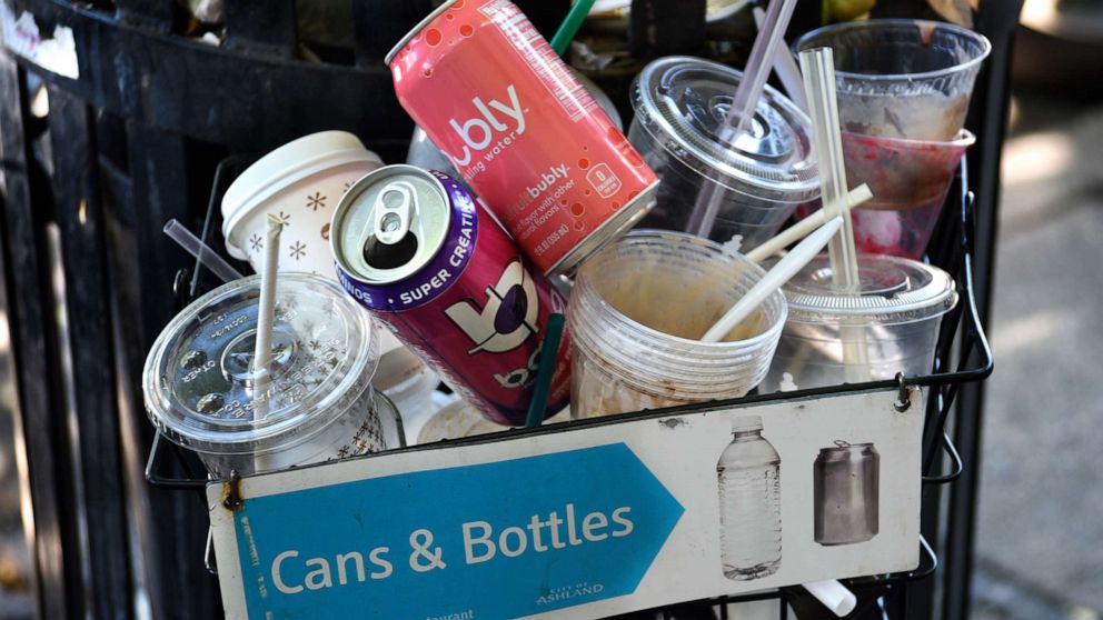 PHOTO: Cups, straws and cans sit in a recycling receptacle in Ashland, Ore., June 17, 2019.