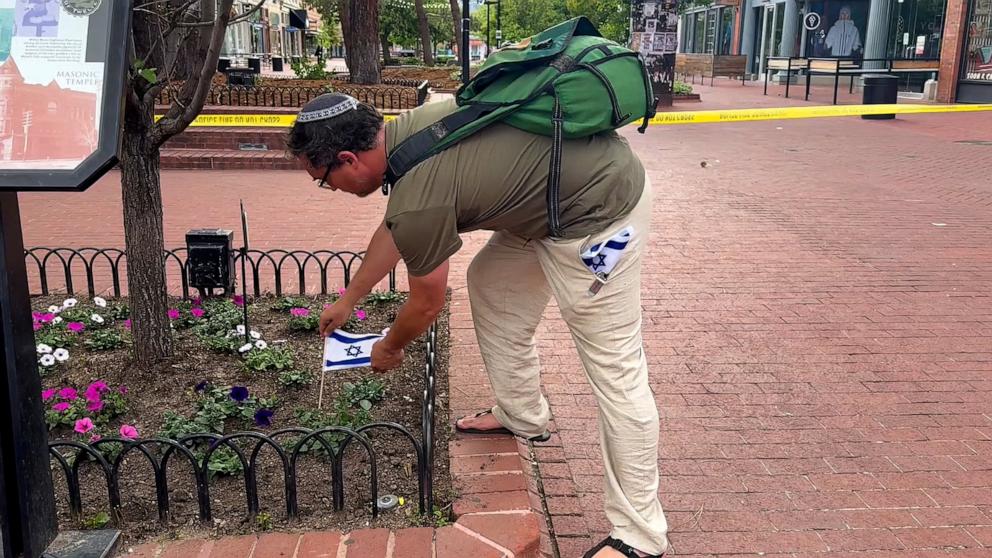 PHOTO: A man places a flag of Israel near the scene of an attack in Boulder, Colorado, June 1, 2025. 