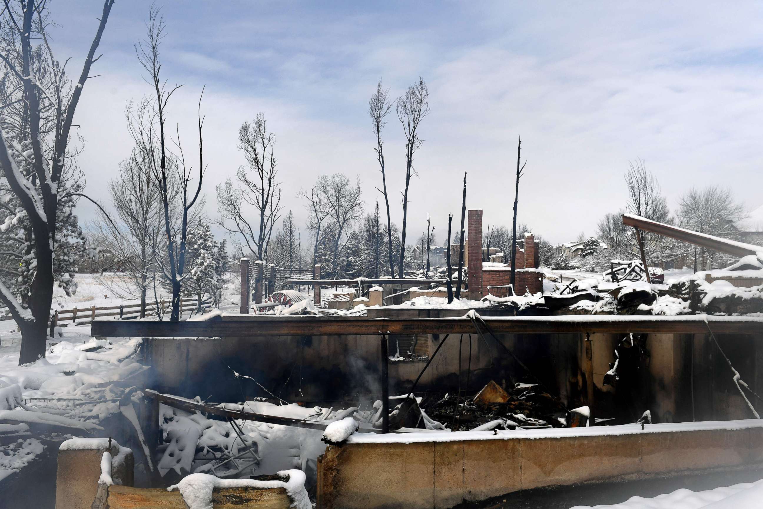 PHOTO: Steam rises from the snow-covered remains of homes destroyed by the Marshall Fire in the Rock Creek neighborhood of the town of Superior in Boulder County, Colorado, Jan. 1, 2022.