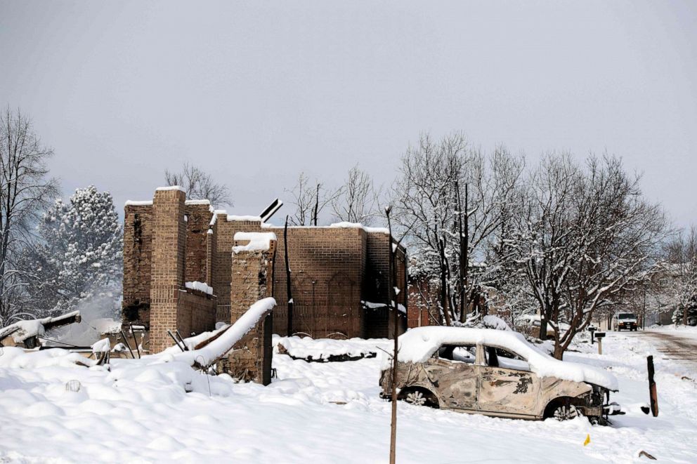 PHOTO: A snow covered car destroyed by the Marshall Fire is seen near destroyed homes in the Rock Creek neighborhood of Superior in Boulder County, Colorado, Jan. 1, 2022.