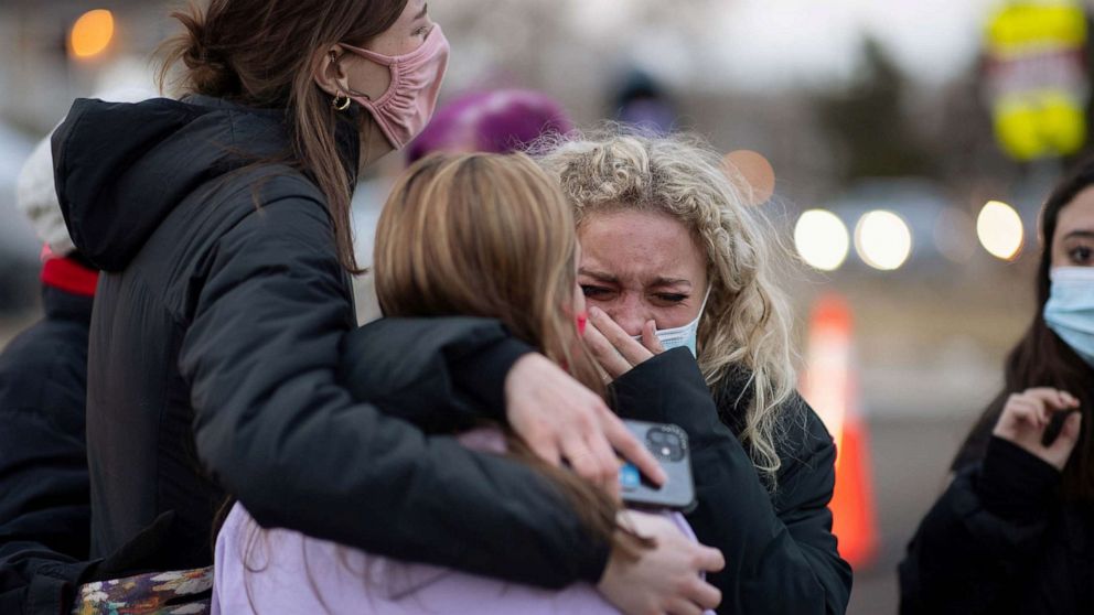 PHOTO: Josie Elowsky cries and hugs her friend, Nirbisha Shetsha, at the site of a mass shooting at King Soopers grocery store in Boulder, Colo., March 23, 2021.