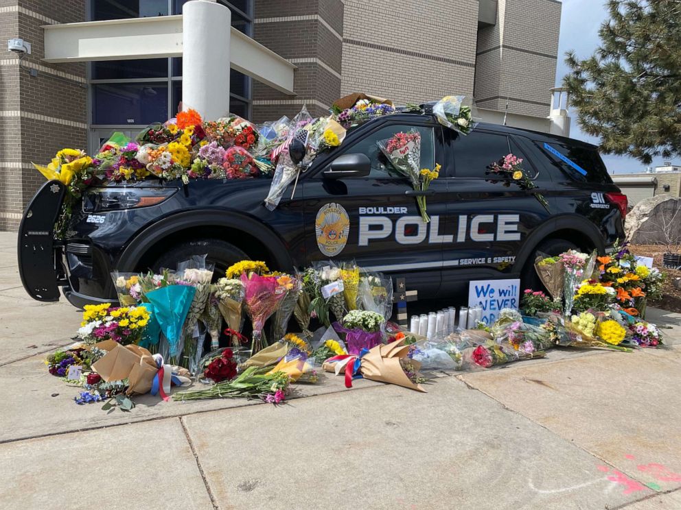 PHOTO: The police car driven by Officer Eric Talley, who was killed in a mass shooting at King Soopers grocery store in Boulder, Colo., is covered with flowers in front of the Boulder Police Department on March 23, 2021.