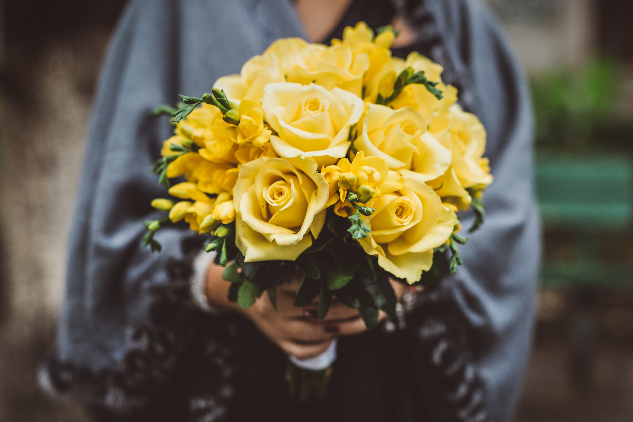 PHOTO: A woman holds a bouquet of yellow roses in this stock image. 