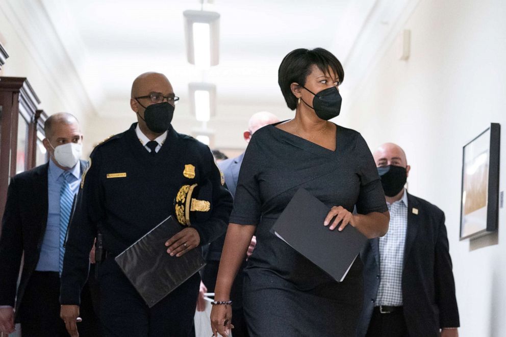 PHOTO: Washington Mayor Muriel Bowser, center-right, walks with Washington Metropolitan Police Chief Robert Contee III, center-left, before a news conference on Feb. 28, 2022, in Washington.