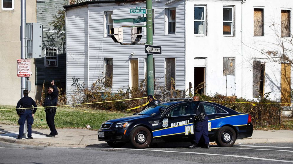 Members of the Baltimore Police Department gather near the scene of the shooting death of Baltimore Police detective Sean Suiter in Baltimore, Nov. 17, 2017. 