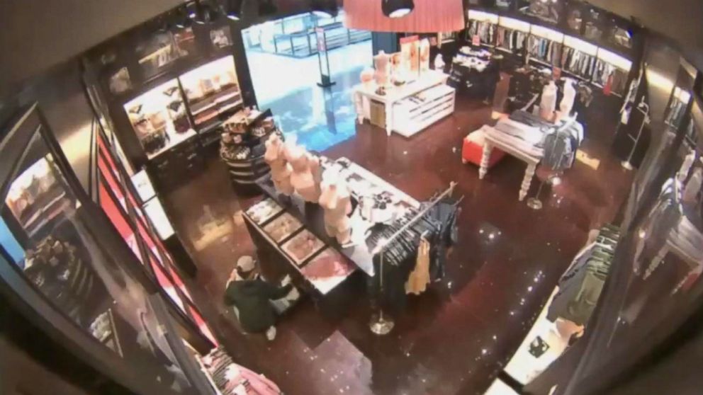 A suspect is seen stealing bras out of a drawer at a Victoria's Secret in Massachusetts.