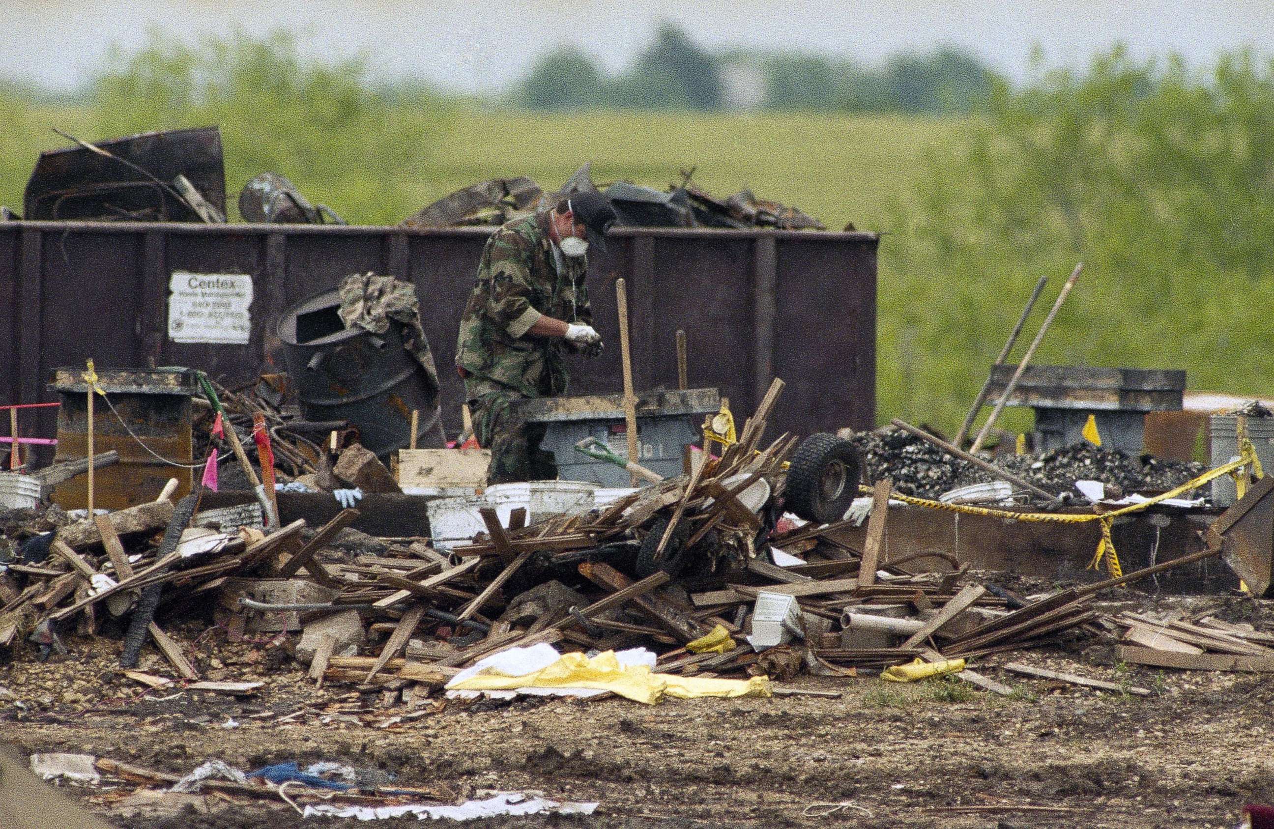 PHOTO: A lone worker sifts through the debris of the burned Branch Davidian compound near Waco, Texas, April 29, 1993.