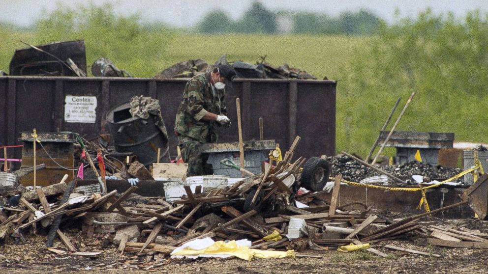 PHOTO: A lone worker sifts through the debris of the burned Branch Davidian compound near Waco, Texas, April 29, 1993.