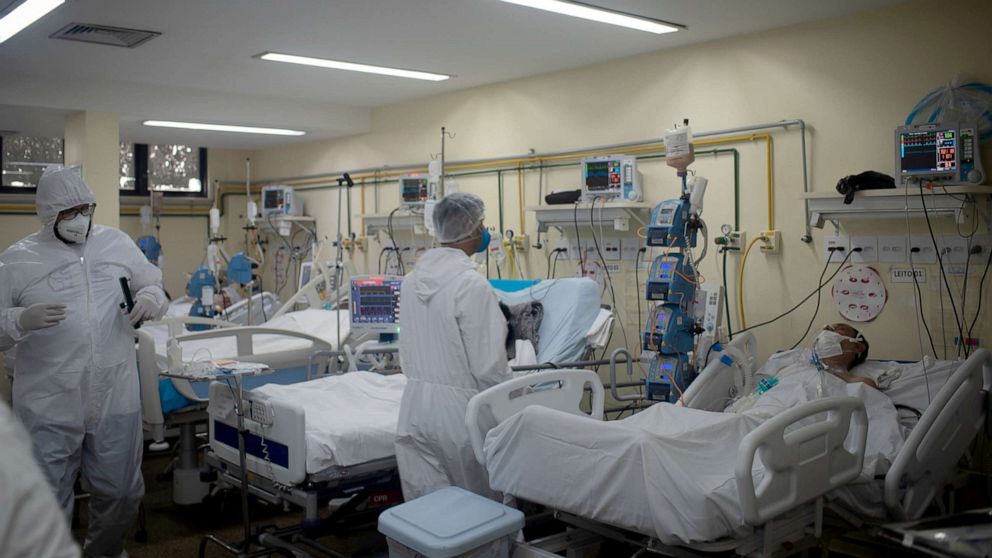 PHOTO: Health workers with their personal protection equipment in the intensive cares area of a hospital in Rio de Janeiro, Brazil, May 27, 2021. 