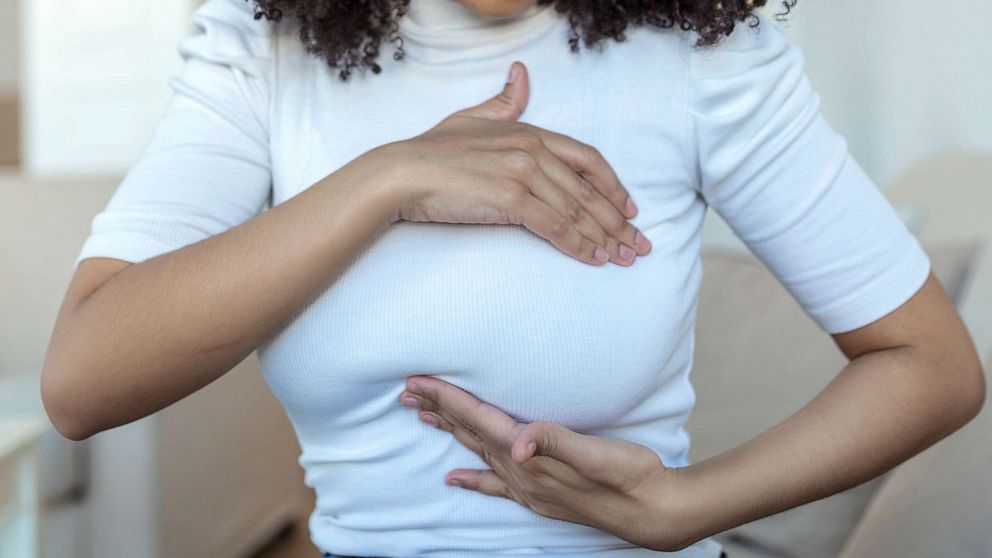 STOCK PHOTO: A woman palpats her breast