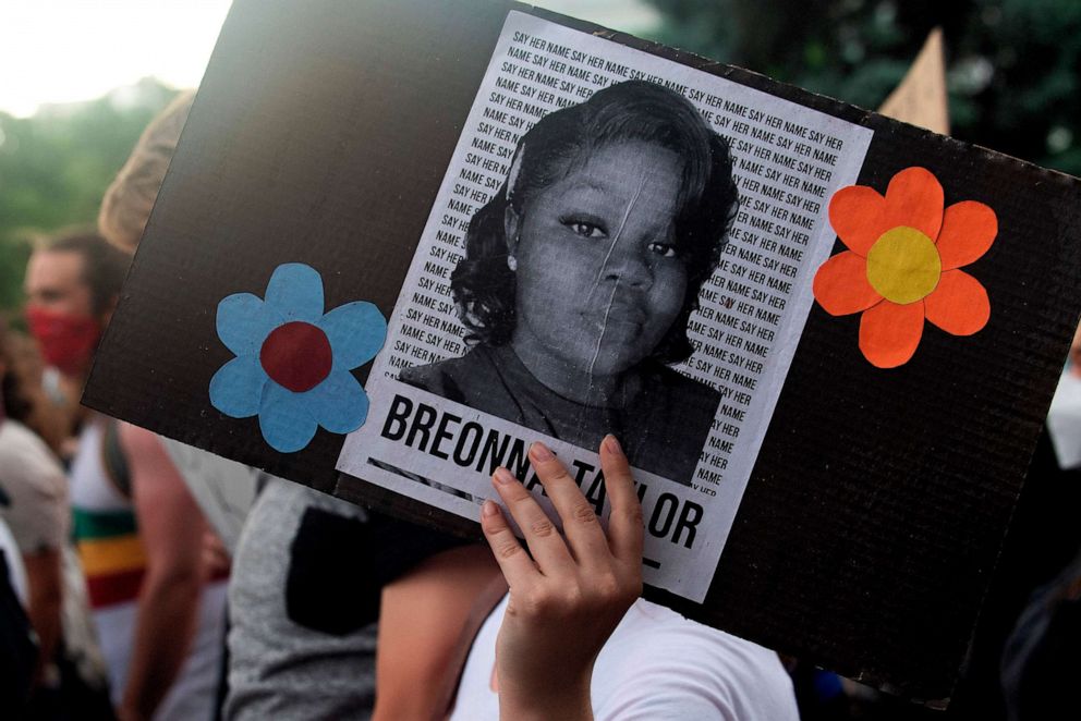 PHOTO: A demonstrator holds a sign with the image of Breonna Taylor, a black woman who was fatally shot by Louisville Metro Police Department officers, during a protest against the death George Floyd in Minneapolis, in Denver, June 3, 2020. 