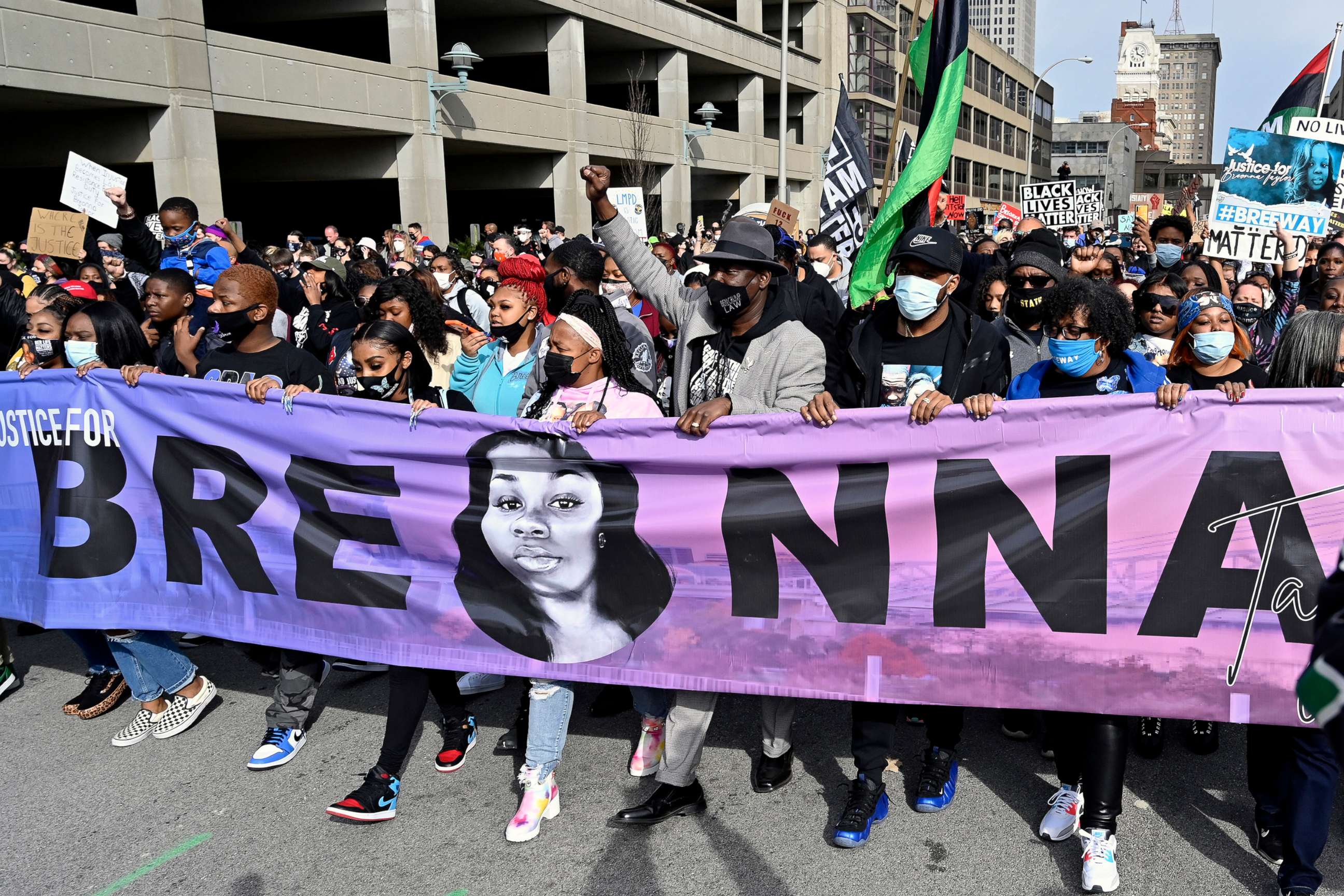 PHOTO: Breonna Taylor's mother Tamika Palmer, center, leads a march through the streets of downtown Louisville on the one year anniversary of Taylor's death on March 13, 2021, in Louisville, Ky. 