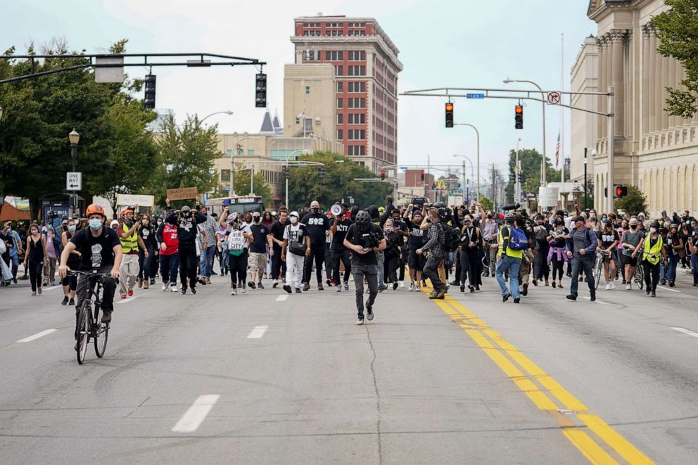 PHOTO: People react after a decision in the criminal case against police officers involved in the death of Breonna Taylor, who was shot dead by police in her apartment, in Louisville, Ky., Sept. 23, 2020.