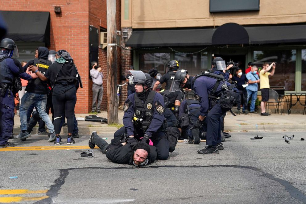 PHOTO: A police officer detains a protester as people react after a decision in the criminal case against police officers involved in the death of Breonna Taylor, who was shot dead by police in her apartment, in Louisville, Ky., Sept. 23, 2020.