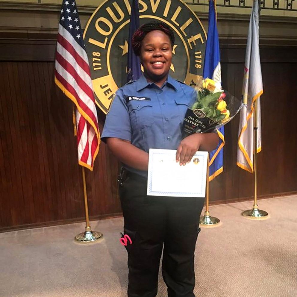 PHOTO: This undated photo courtesy of Breonna Taylor family shows Breonna posing during a graduation ceremony in Louisville, Ky.