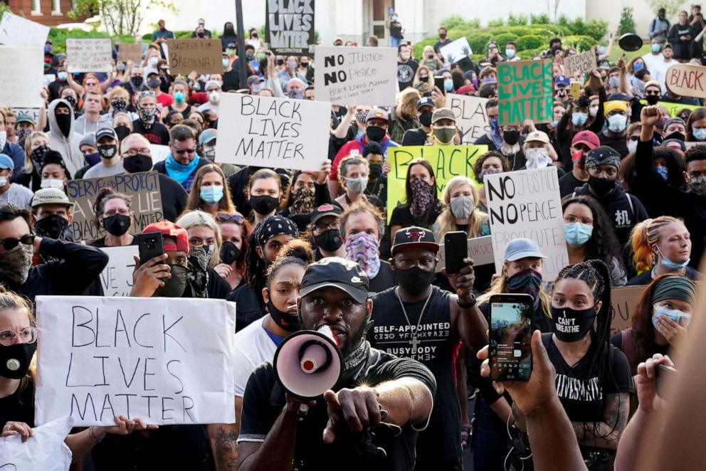PHOTO: People gather in front of Louisville City Hall during a protest against the deaths of Breonna Taylor by Louisville police and George Floyd by Minneapolis police, in Louisville, Ky., May 29, 2020.
