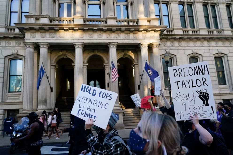 PHOTO: People march past City Hall during a protest against the deaths of Breonna Taylor by Louisville police and George Floyd by Minneapolis police, in Louisville, Kentucky, May 29, 2020.