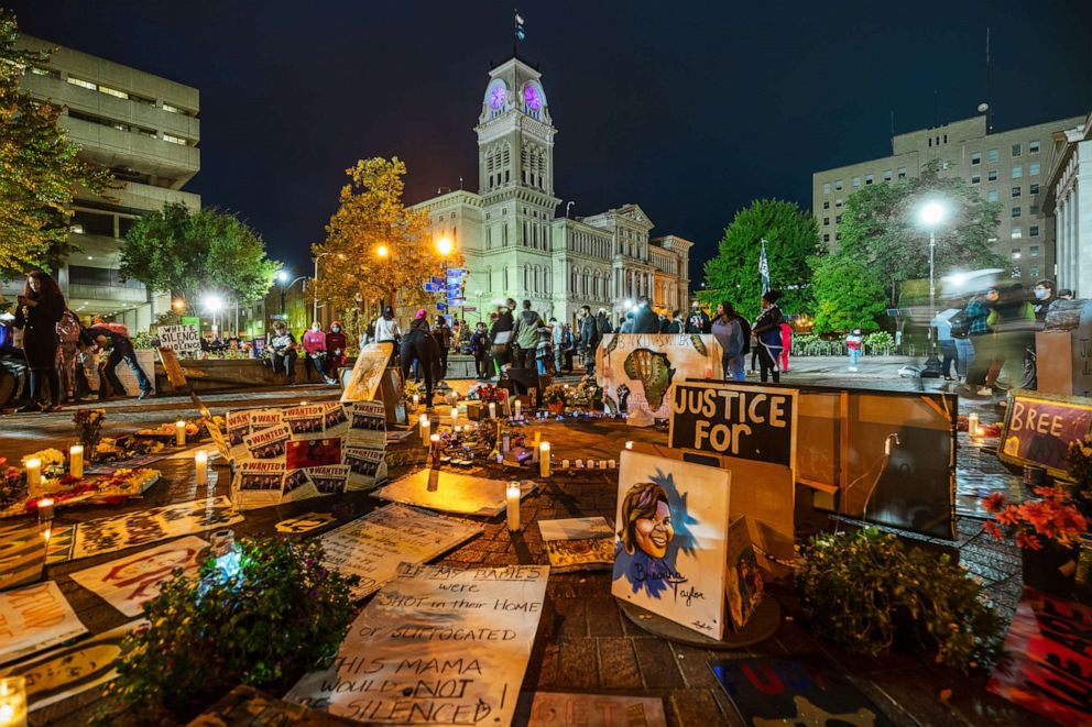 PHOTO: Demonstrators and members of the Black Women's Collective gather around the Breonna Taylor memorial at Jefferson Square Park on Oct. 3, 2020, in Louisville, Ky.