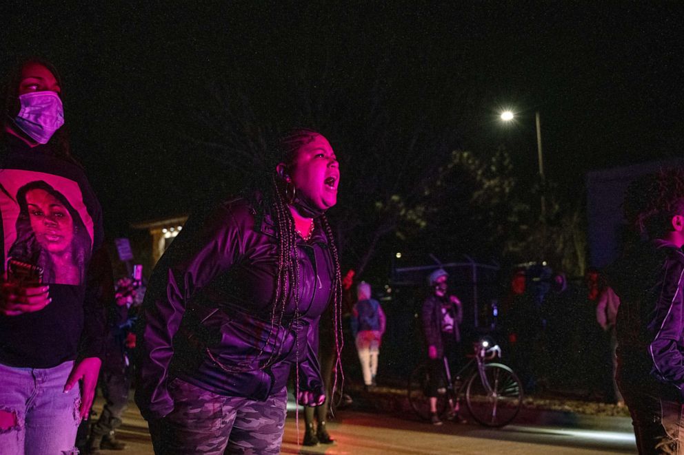 PHOTO: A protester shout at police officers in front of her and the crowd after the Breonna Taylor memorial events, March 13, 2021, in Louisville, Kentucky.