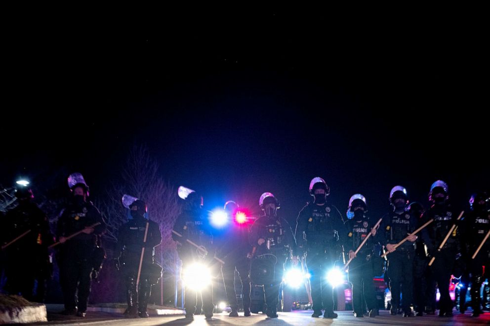 PHOTO: Louisville Metro Police Department officers march toward a group of protesters after the Breonna Taylor memorial events, March 13, 2021, in Louisville, Kentucky.