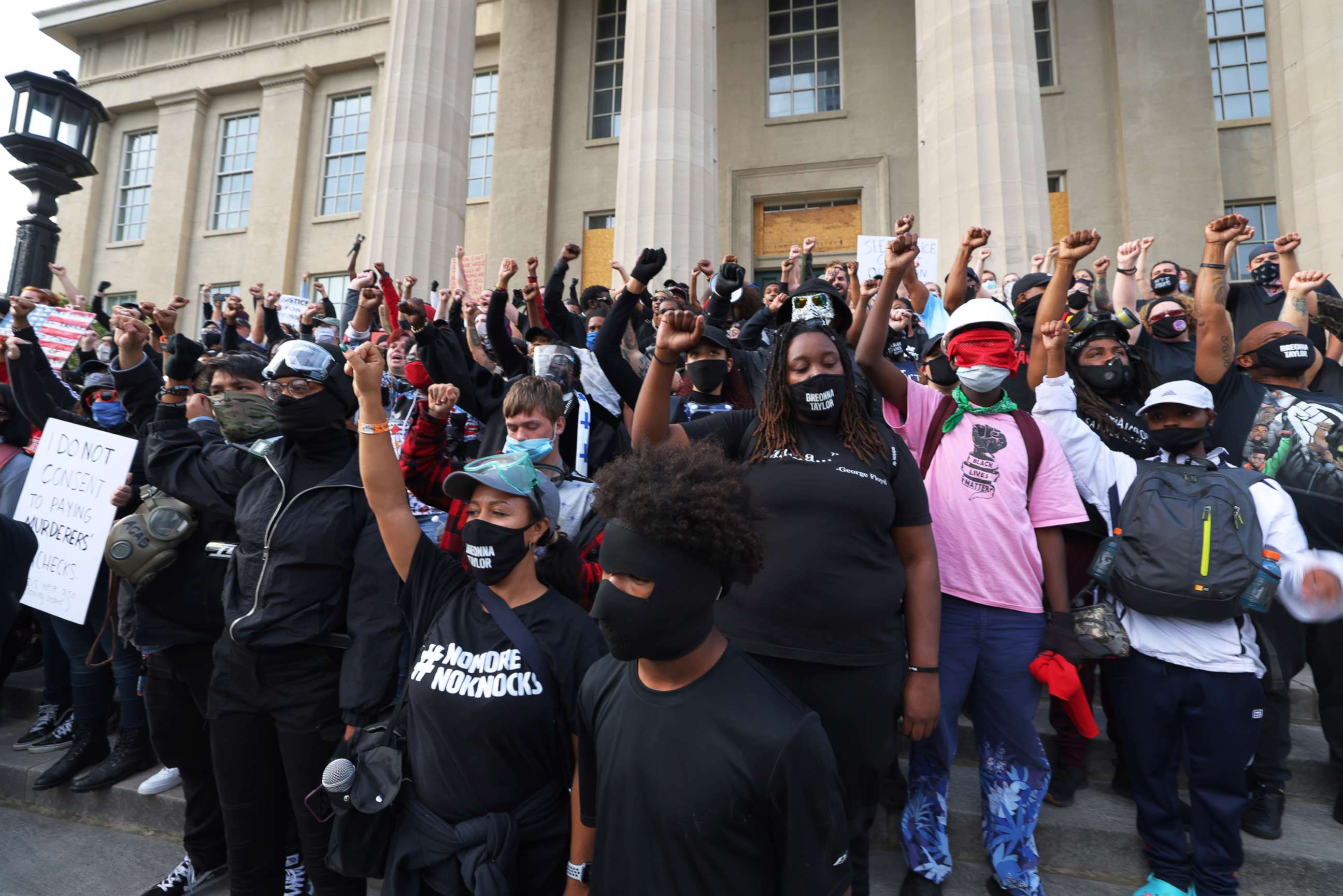 PHOTO: In this Sept. 24, 2020, file photo, demonstrators raise their fists on the steps of the Louisville Metro Hall after a Kentucky grand jury indicted a police officer involved in the shooting of Breonna Taylor with three counts of wanton endangerment.
