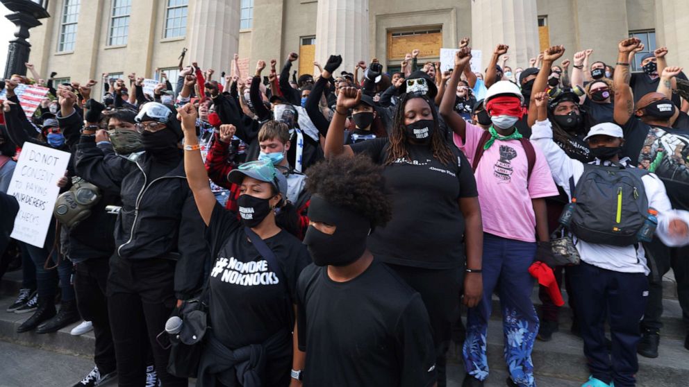 PHOTO: In this Sept. 24, 2020, file photo, demonstrators raise their fists on the steps of the Louisville Metro Hall after a Kentucky grand jury indicted a police officer involved in the shooting of Breonna Taylor with three counts of wanton endangerment.