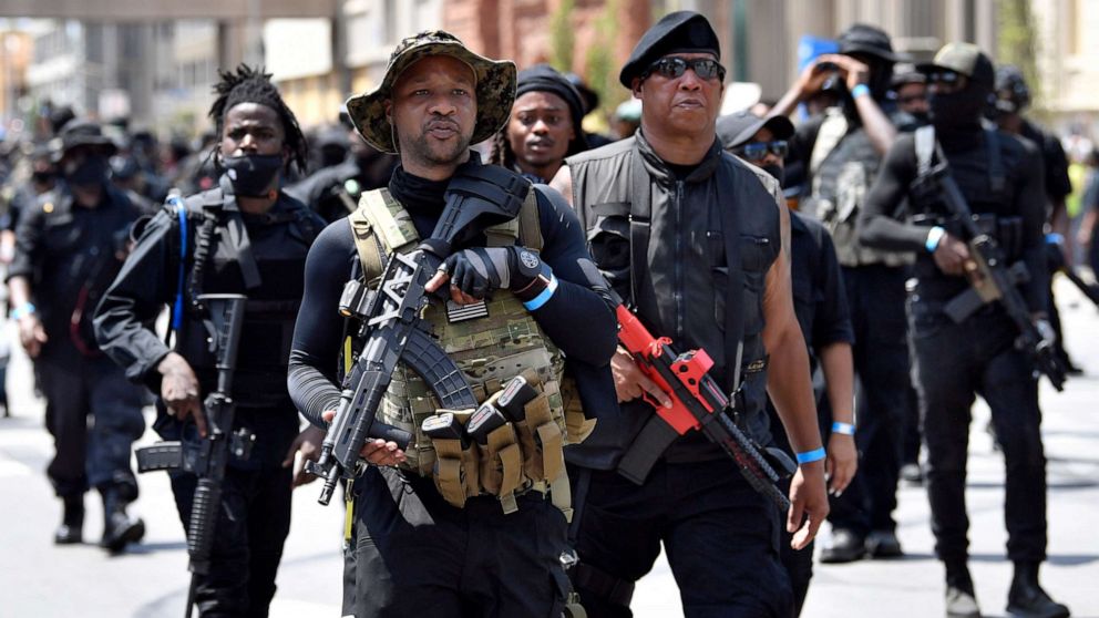 PHOTO: Armed members of the "NAFC" march through downtown toward the Hall of Justice in Louisville, Ky., Saturday, July 25, 2020.