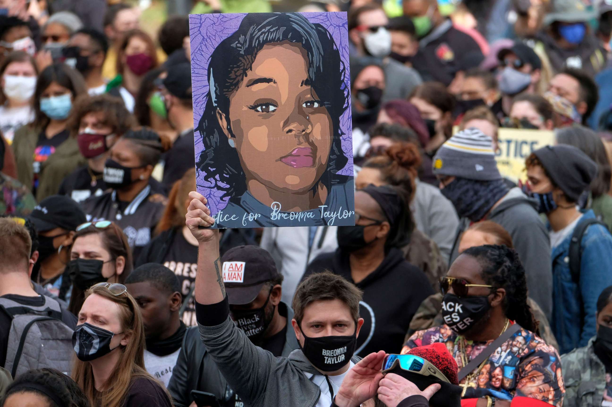 PHOTO: A protestor brandishes a portrait of Breonna Taylor during a rally in remembrance on the one year anniversary of her death in Louisville, Kentucky, March 13, 2021. 