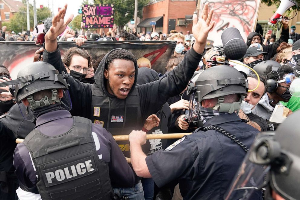 PHOTO: A protester clashes with police after a grand jury considering the March killing of Breonna Taylor in her home, voted to indict one of three white police officers for wanton endangerment, in Louisville, Ky., Sept. 23, 2020.