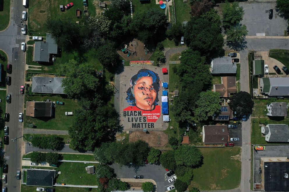 PHOTO: A large-scale ground mural depicting Breonna Taylor with the text 'Black Lives Matter' is painted at Chambers Park, July 5, 2020, in Annapolis, Md.