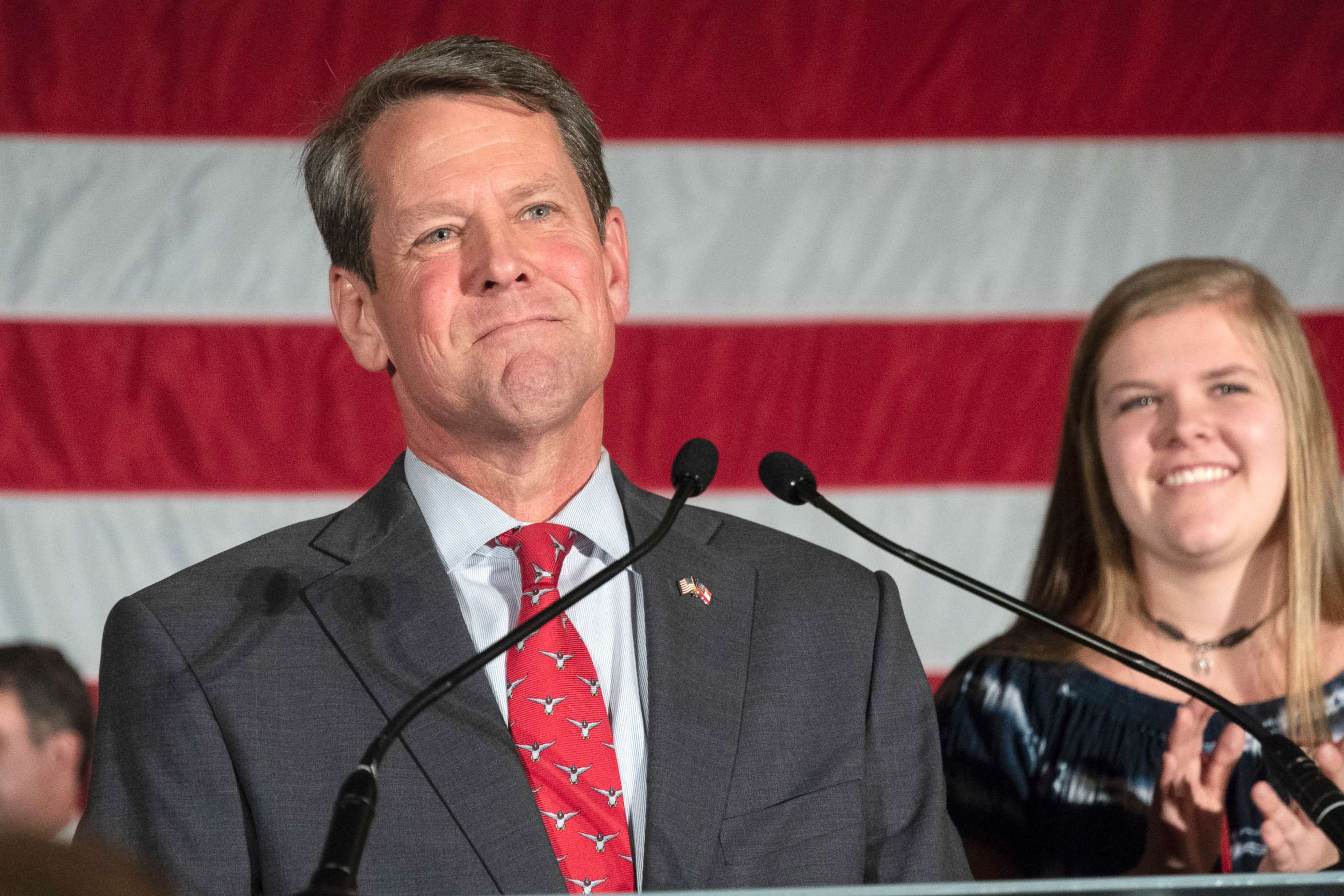 PHOTO: Georgia Secretary of State Brian Kemp appears during a unity rally with daughter Lucy behind him, July 26, 2018, in Peachtree Corners, Ga.