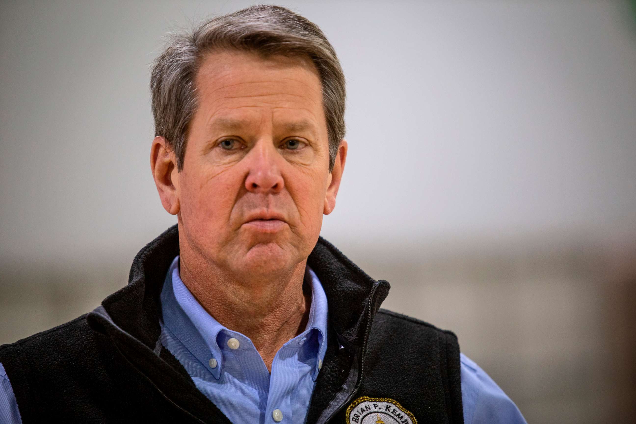 PHOTO: Georgia Gov. Brian Kemp listens to a question from the press during a tour of a temporary hospital at the Georgia World Congress Center in Atlanta, April 16, 2020.