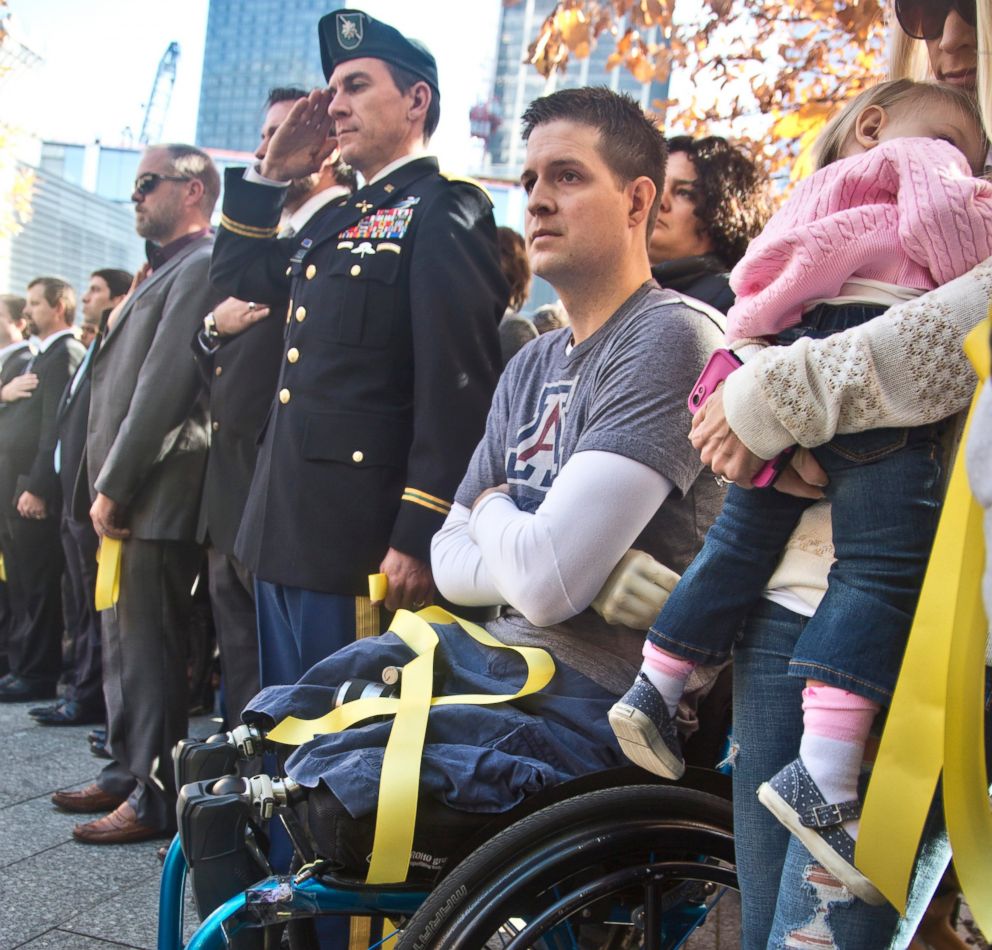 PHOTO: In this Nov. 10, 2014, file photo, former U.S. Air Force Senior Airman Brian Kolfage, center, sits in a wheelchair next to his wife Ashley, right, during the National September 11 Memorial and Museum's "Salute to Service" tribute.