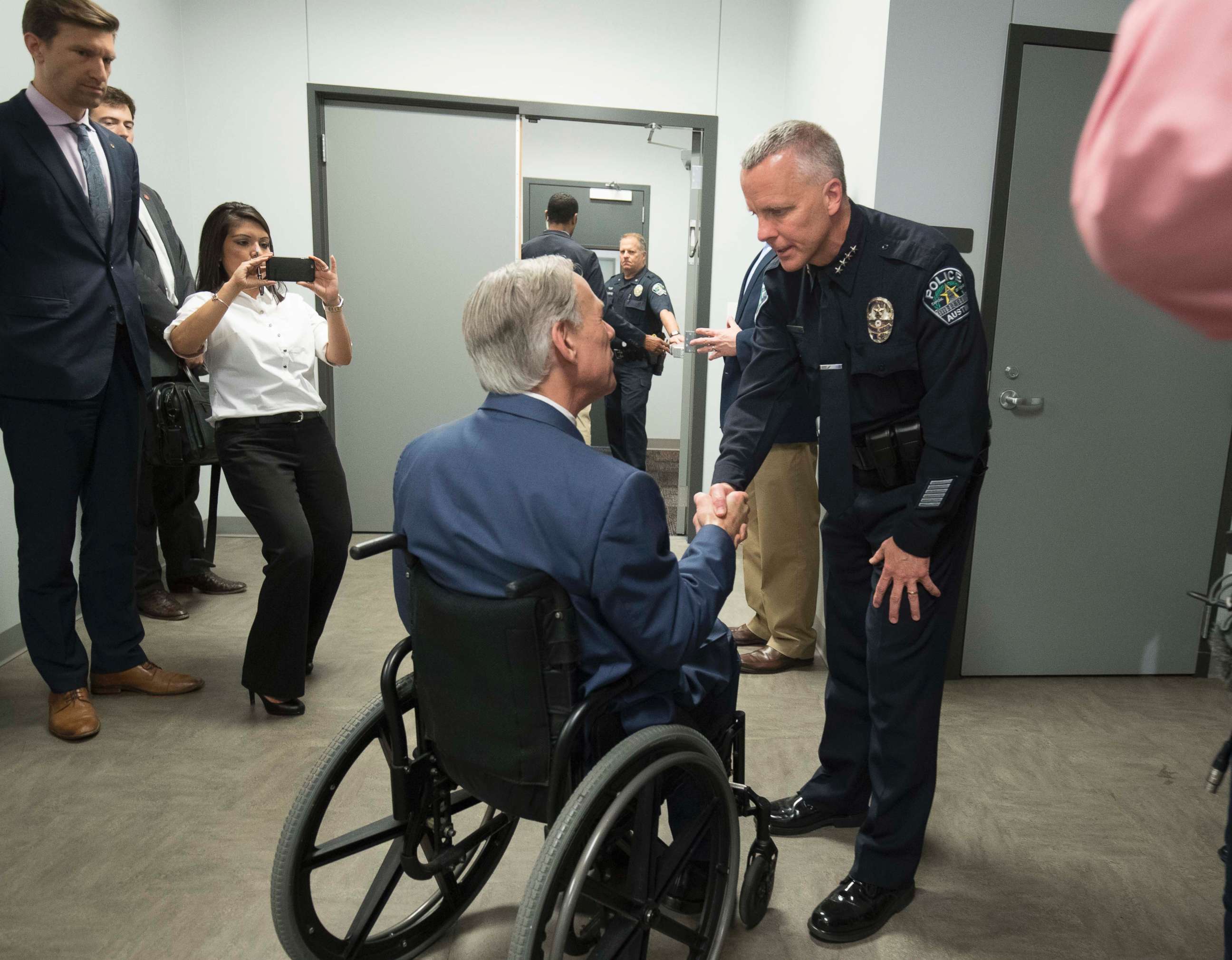 PHOTO:Austin Police Chief Brian Manley, right, shakes the hand of Gov. Greg Abbott of Texas as he leads a congratulatory press conference with the governor and others who assisted in bringing down the serial Austin bomber, March 21, 2018.