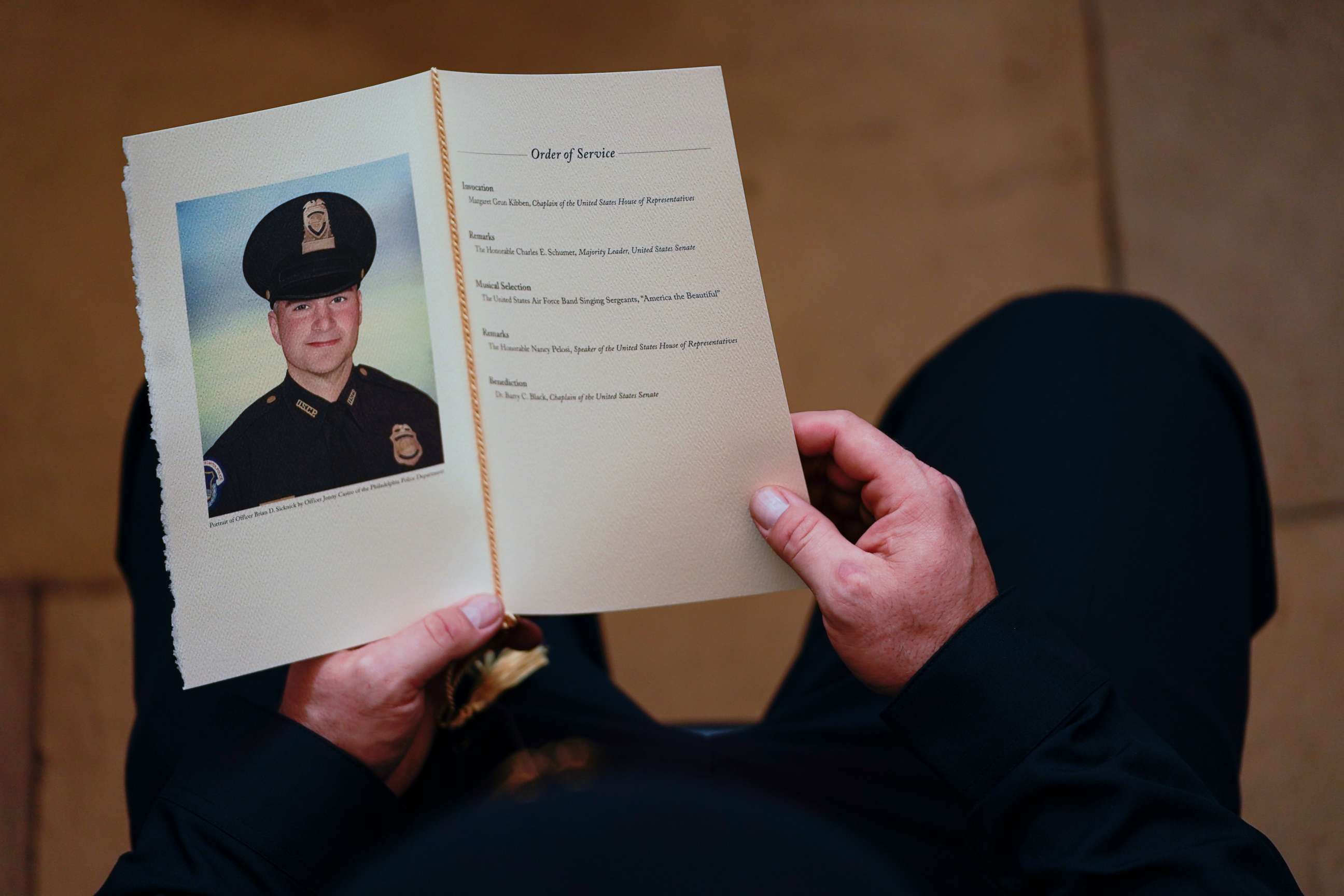 PHOTO: A U.S. Capitol Police Officer holds a program for the ceremony memorializing U.S. Capitol Police Officer Brian D. Sicknick, 42, as he lies in honor in the Rotunda of the Capitol on Feb. 3, 2021, in Washington D.C.